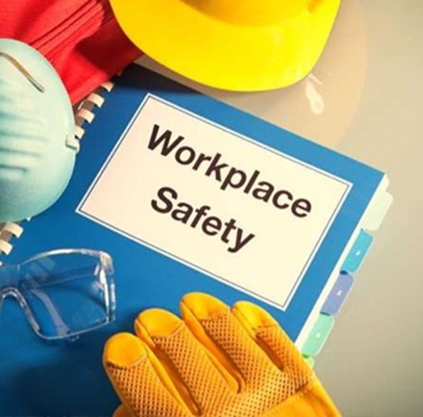 Workplace safety booklet with protective gloves and helmet